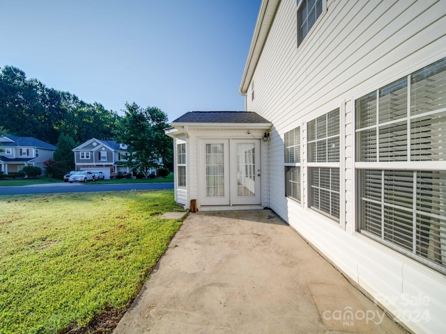 doorway to property featuring a patio and a yard