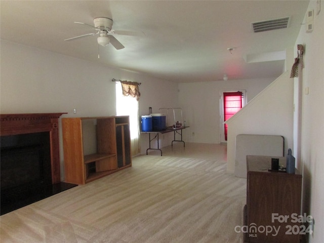 living room with light carpet and ceiling fan