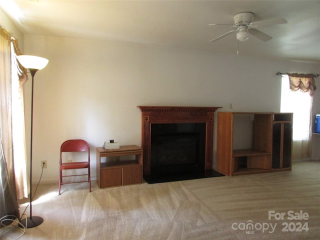 carpeted living room with ceiling fan