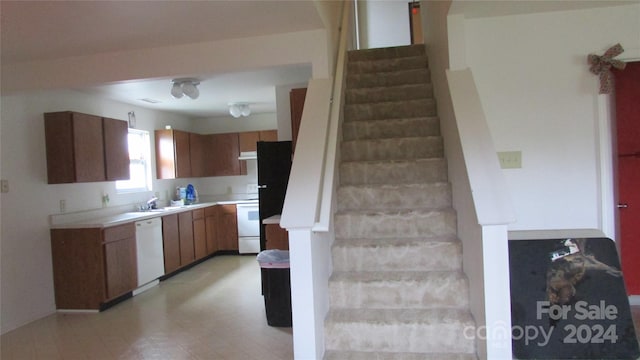 kitchen featuring white appliances and sink