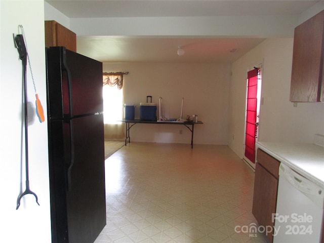 kitchen featuring dishwasher and black refrigerator