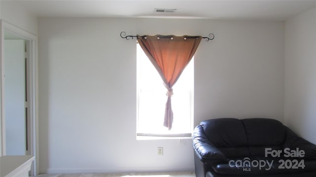 sitting room with light colored carpet