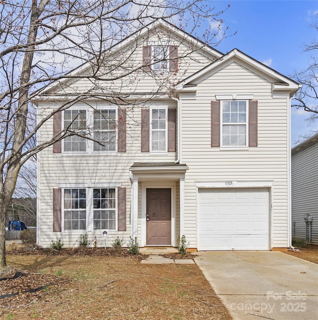 traditional home featuring an attached garage and driveway