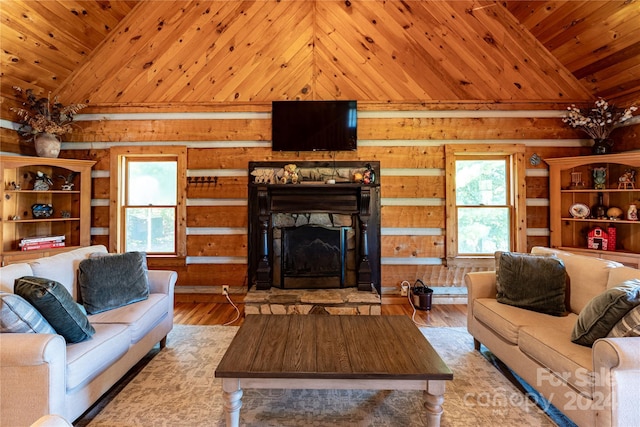 living room with lofted ceiling, wooden ceiling, a stone fireplace, and wood finished floors