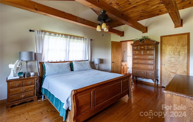 bedroom featuring a ceiling fan, wood ceiling, wood-type flooring, and beamed ceiling