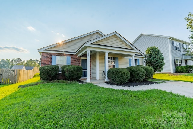 view of front of house with a front yard and covered porch