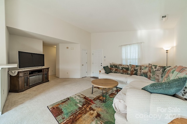 carpeted living room featuring lofted ceiling