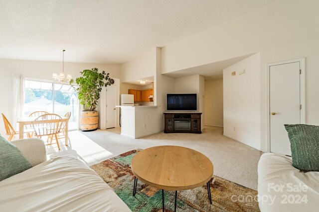 carpeted living room with vaulted ceiling and a chandelier