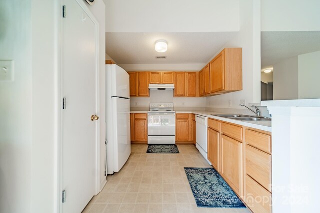 kitchen featuring light tile patterned floors, sink, white appliances, and light brown cabinets