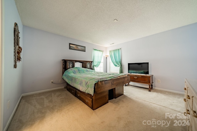 carpeted bedroom featuring a textured ceiling