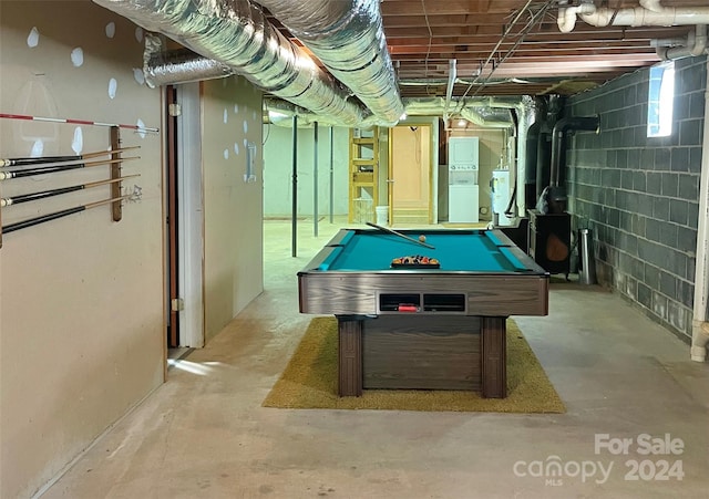 playroom with concrete block wall, pool table, and unfinished concrete flooring