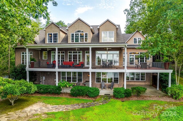 back of house featuring a balcony, ceiling fan, and a patio area