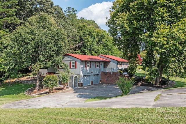 view of front of house with a garage and a front lawn