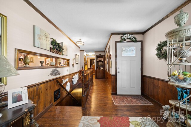 foyer with crown molding and dark hardwood / wood-style flooring