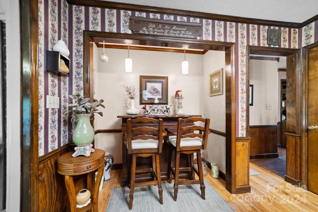 dining room with a textured ceiling and wood-type flooring