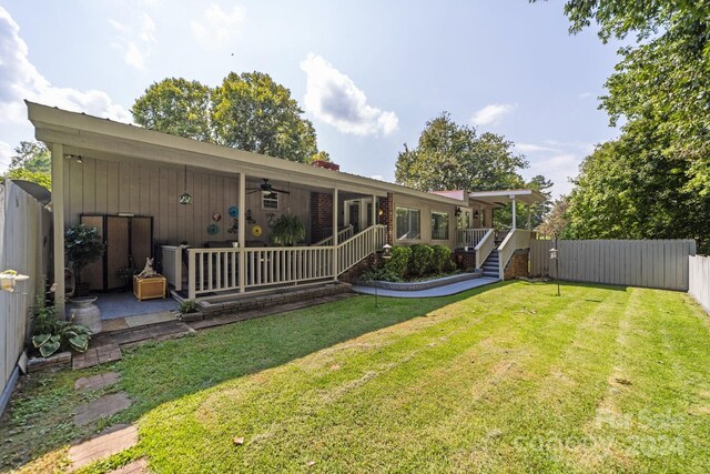 back of property featuring a lawn