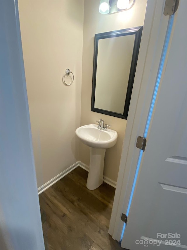 bathroom with hardwood / wood-style flooring