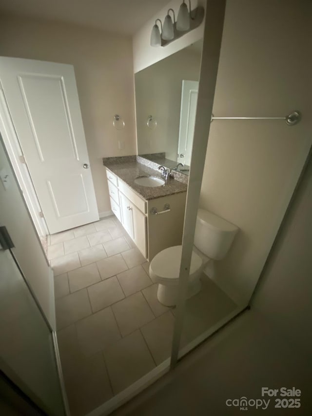 bathroom featuring vanity, toilet, and tile patterned floors