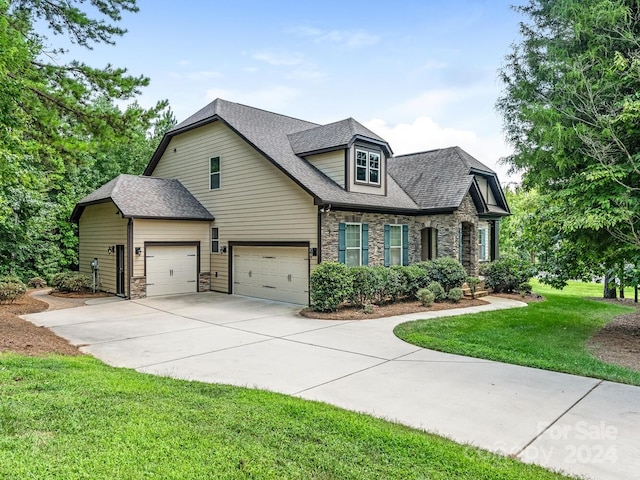 view of front of property featuring a garage and a front lawn