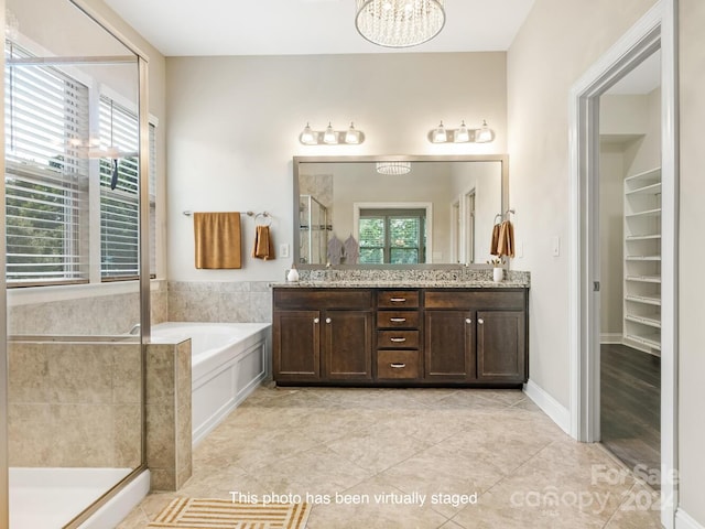 bathroom featuring independent shower and bath, double vanity, and tile patterned floors