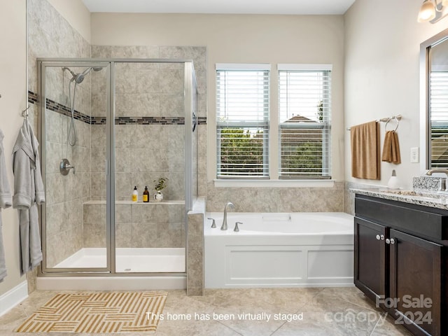 bathroom featuring tile patterned flooring, independent shower and bath, and vanity