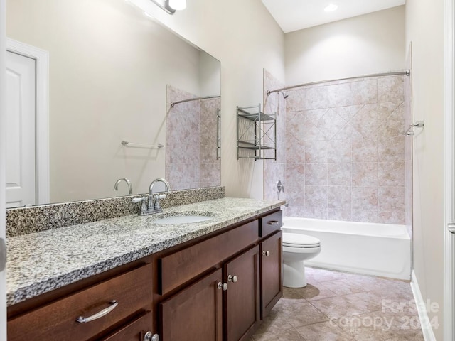 full bathroom featuring toilet, tiled shower / bath, tile patterned flooring, and vanity