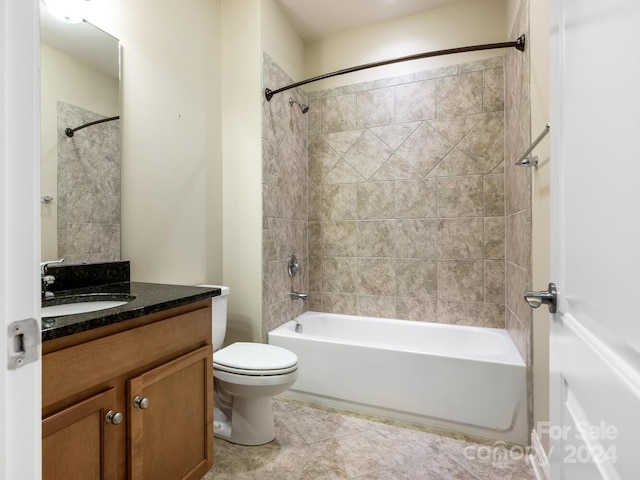 full bathroom featuring toilet, tiled shower / bath combo, tile patterned flooring, and vanity