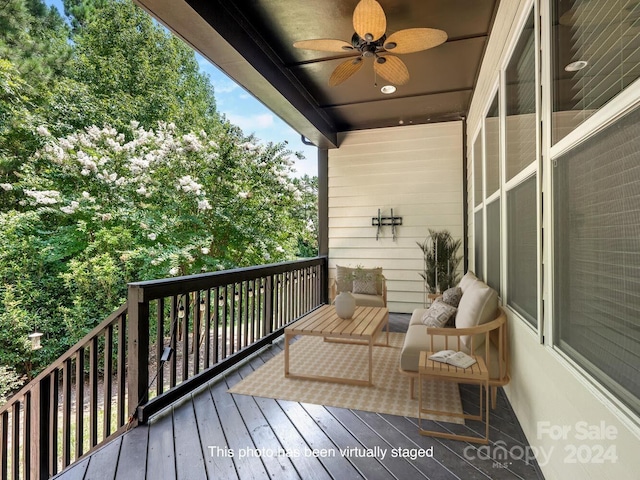 deck with an outdoor living space and ceiling fan