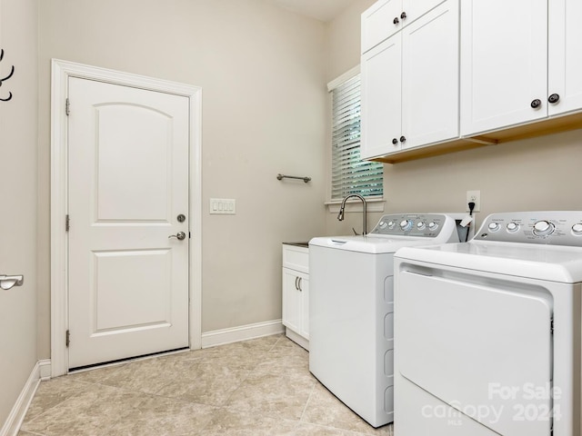 washroom with light tile patterned floors, independent washer and dryer, and cabinets