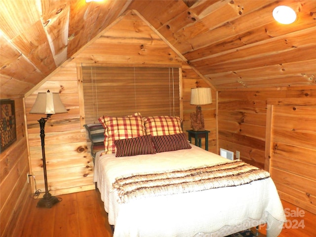 unfurnished bedroom with wooden walls, vaulted ceiling, wooden ceiling, and wood-type flooring