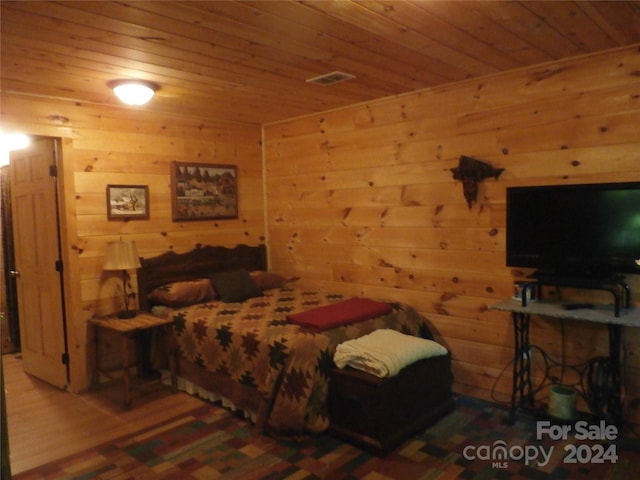 bedroom featuring wooden walls, wood ceiling, and wood-type flooring