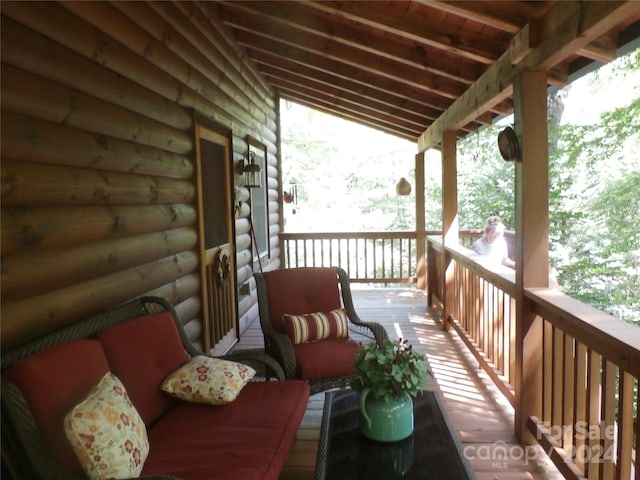 wooden deck with an outdoor living space