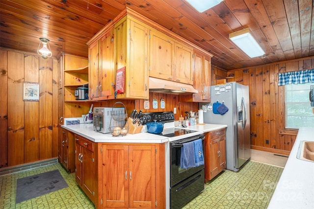 kitchen featuring wooden walls, under cabinet range hood, light countertops, stainless steel fridge with ice dispenser, and electric range oven