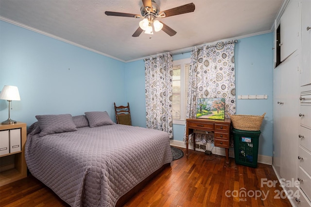 bedroom with ornamental molding and wood finished floors