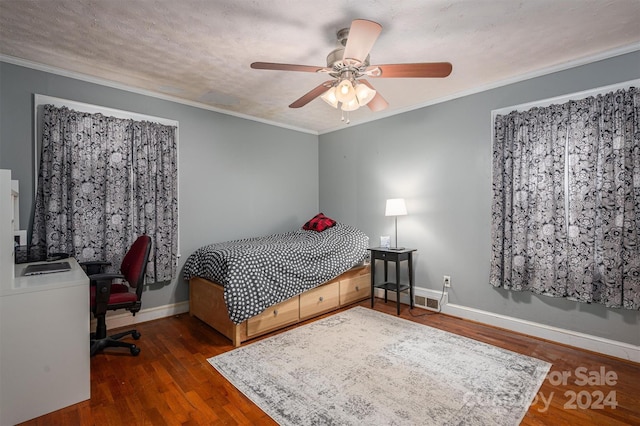 bedroom featuring ornamental molding, ceiling fan, a textured ceiling, wood finished floors, and baseboards