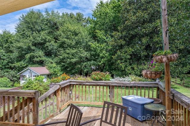 wooden deck featuring a lawn