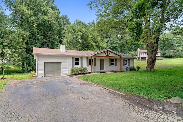 single story home featuring a front yard and a garage