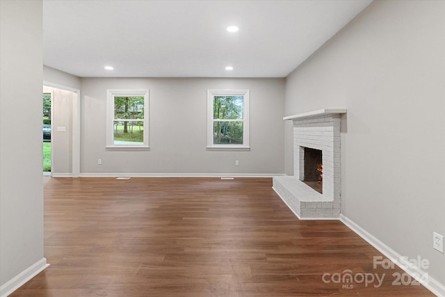 unfurnished living room featuring a fireplace and wood-type flooring