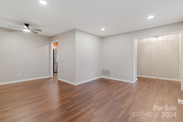 empty room with ceiling fan and hardwood / wood-style flooring