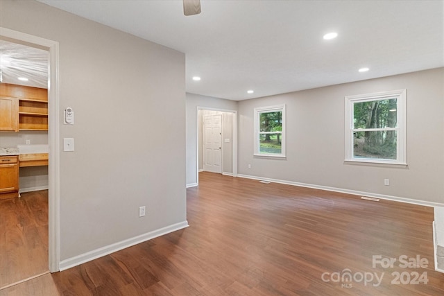 unfurnished room with hardwood / wood-style floors