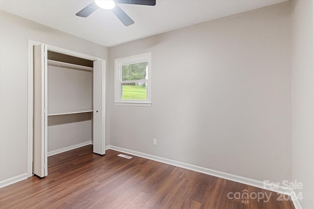 unfurnished bedroom featuring ceiling fan, hardwood / wood-style flooring, and a closet