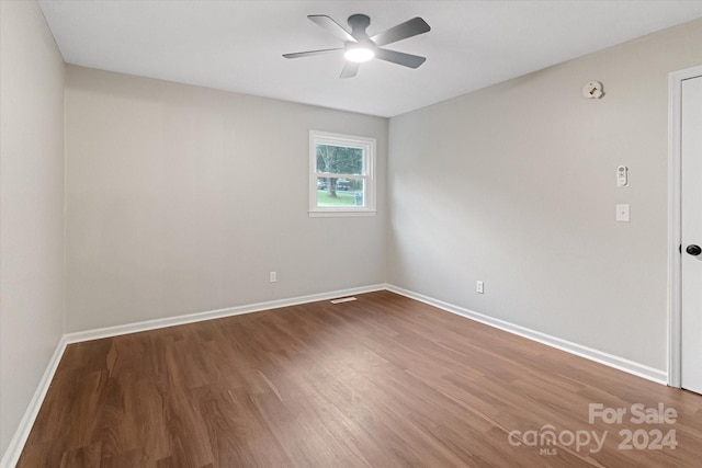 spare room featuring hardwood / wood-style floors and ceiling fan