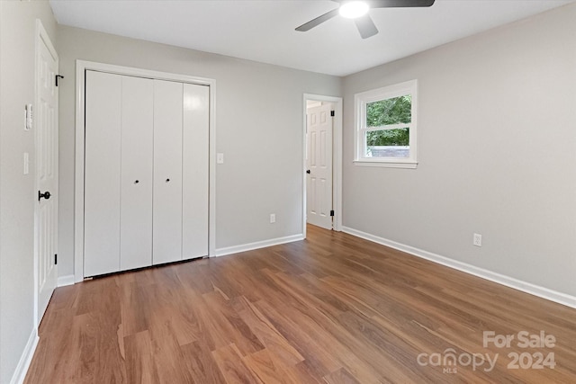 unfurnished bedroom featuring a closet, ceiling fan, and wood-type flooring