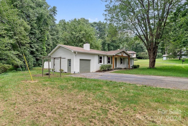 ranch-style home with a garage and a front lawn