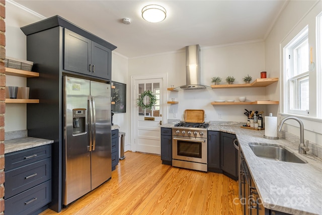 kitchen with crown molding, light hardwood / wood-style flooring, appliances with stainless steel finishes, sink, and wall chimney exhaust hood