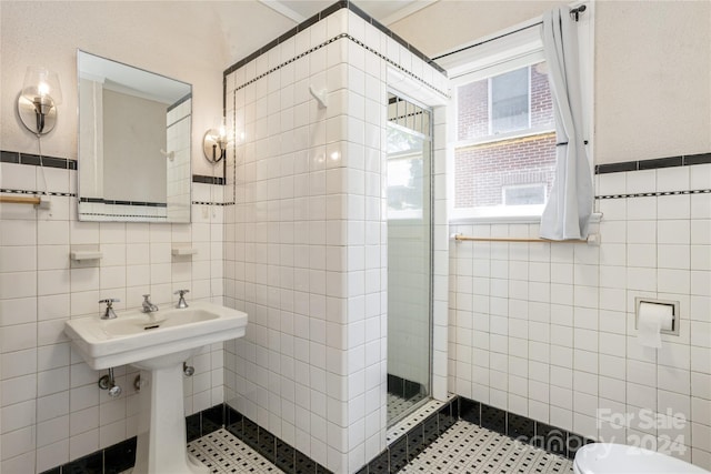 bathroom with tile walls, toilet, and tiled shower