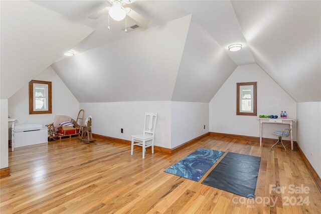 additional living space with lofted ceiling, ceiling fan, and light wood-type flooring