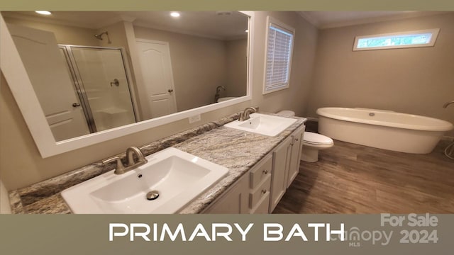 full bathroom featuring vanity, crown molding, hardwood / wood-style flooring, toilet, and independent shower and bath