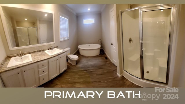 bathroom with vanity, wood-type flooring, ornamental molding, and independent shower and bath