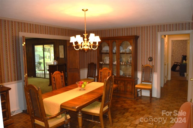 dining area featuring an inviting chandelier and parquet floors